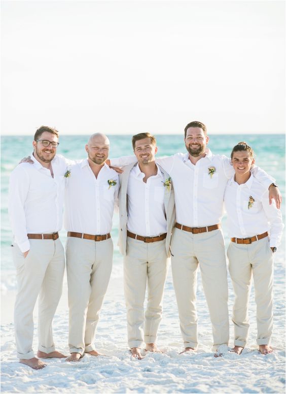 Groom and groomsmen barefoot in white linen on Clearwater Beach