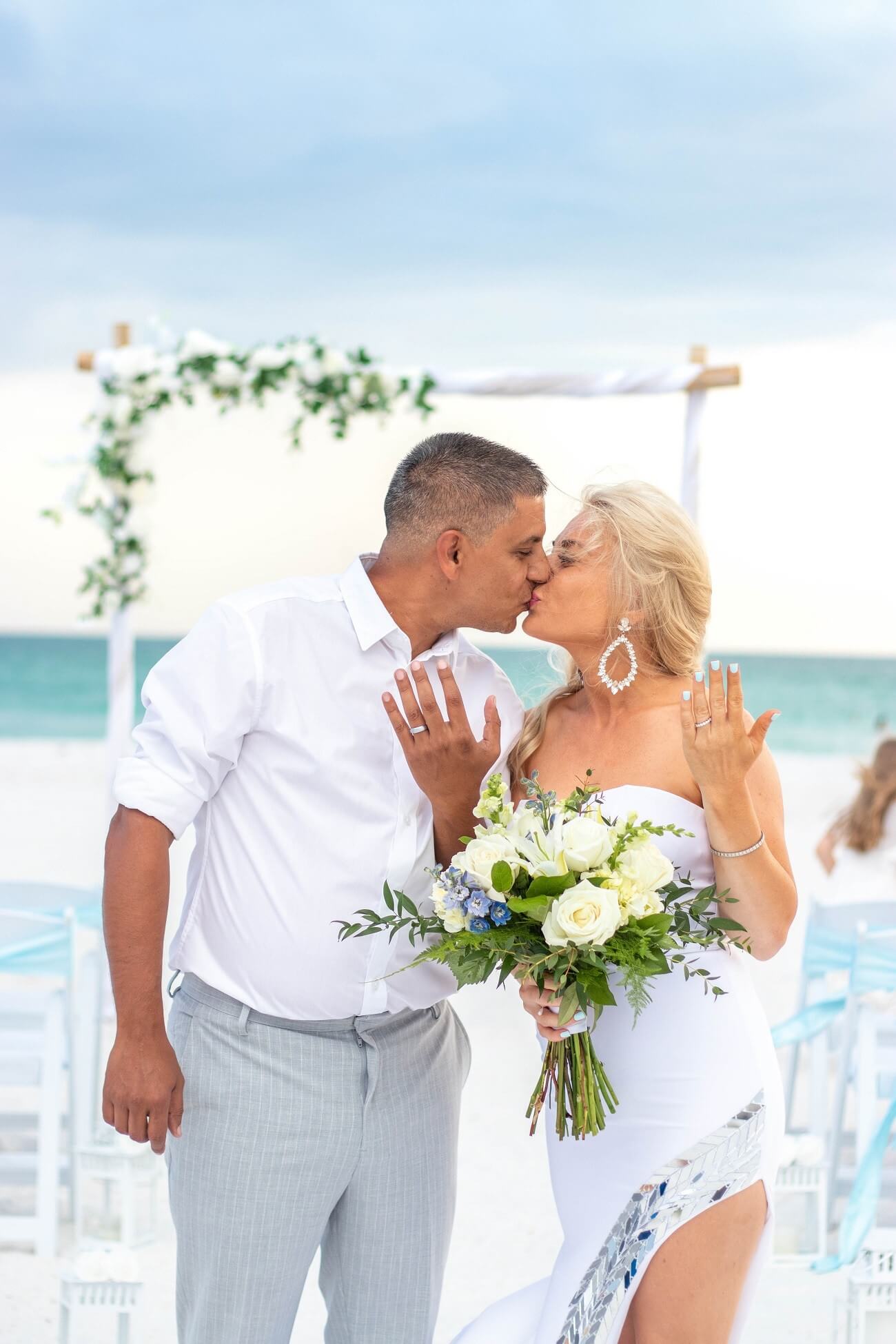 Newlyweds kissing and showing their rings at Pass-a-Grille Beach