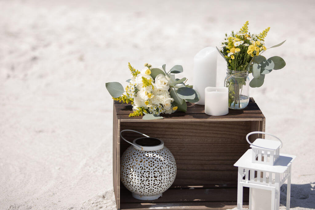 Rustic crate with florals and lanterns on the sand at Sand Key Park