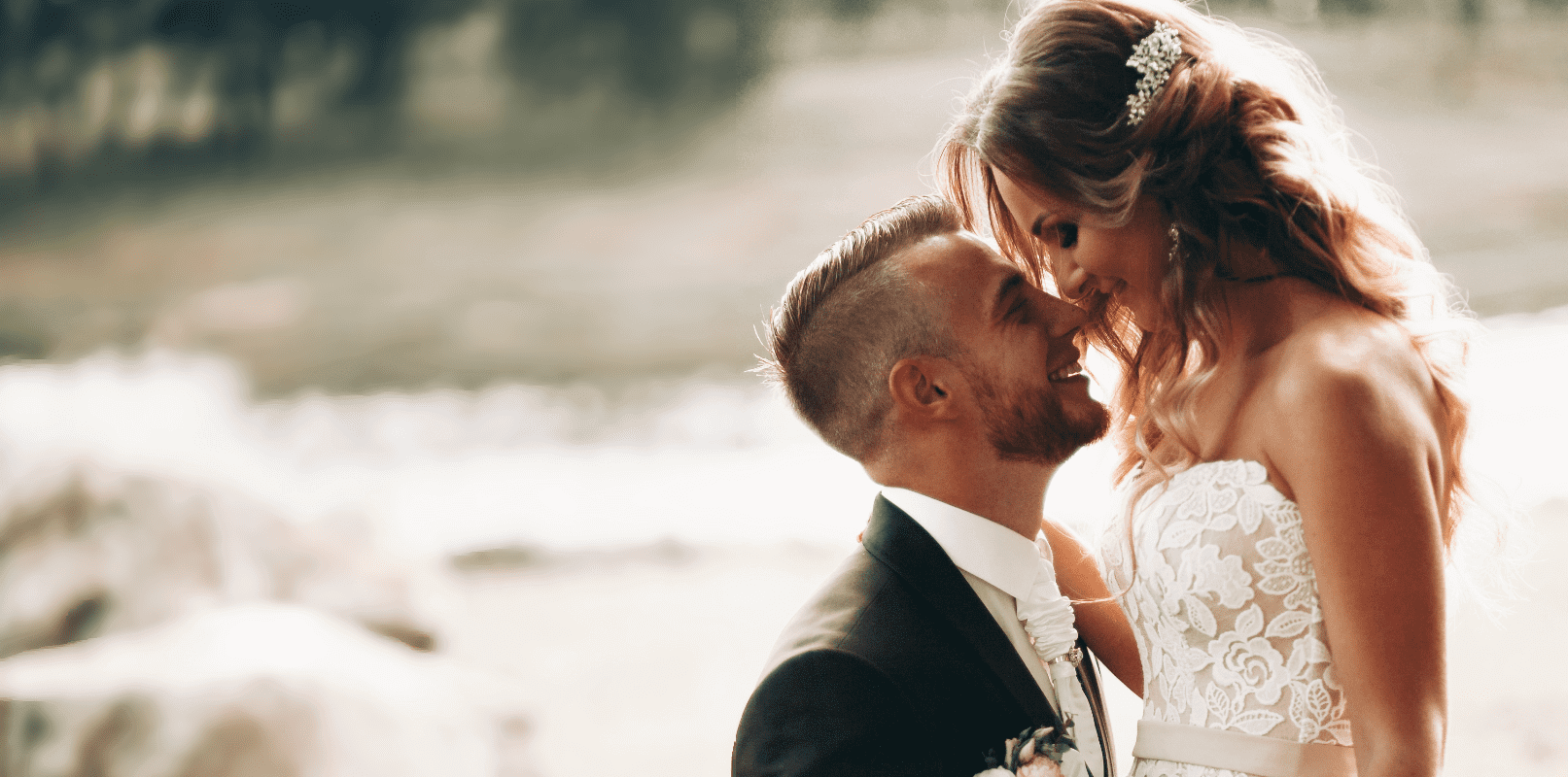 Couple sharing a tender moment in golden light at Sunset Beach