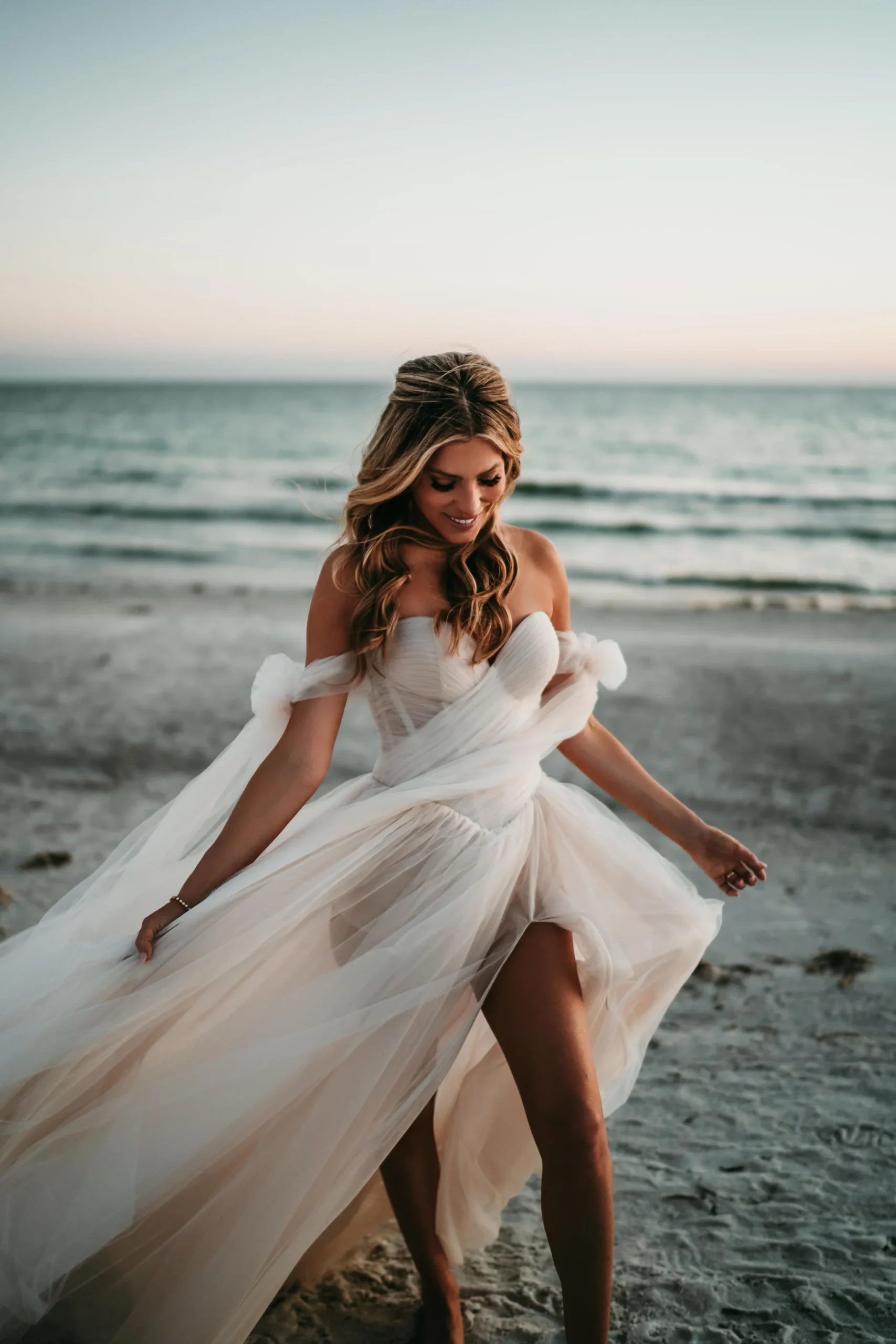 Bride in a flowing tulle gown at dusk on Turtle Beach